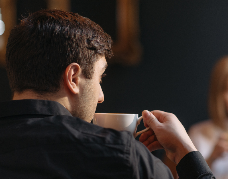 two people mid-conversation, one pausing before responding